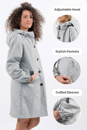 Woman wearing oversized Rain Couture Windbreaker in light grey with adjustable hood, stylish pockets, and cuffed sleeves