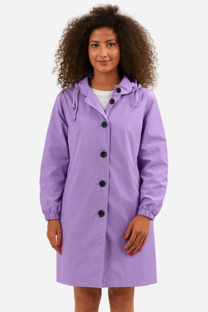 Woman wearing purple oversized Rain Couture Windbreaker jacket with buttons and hood