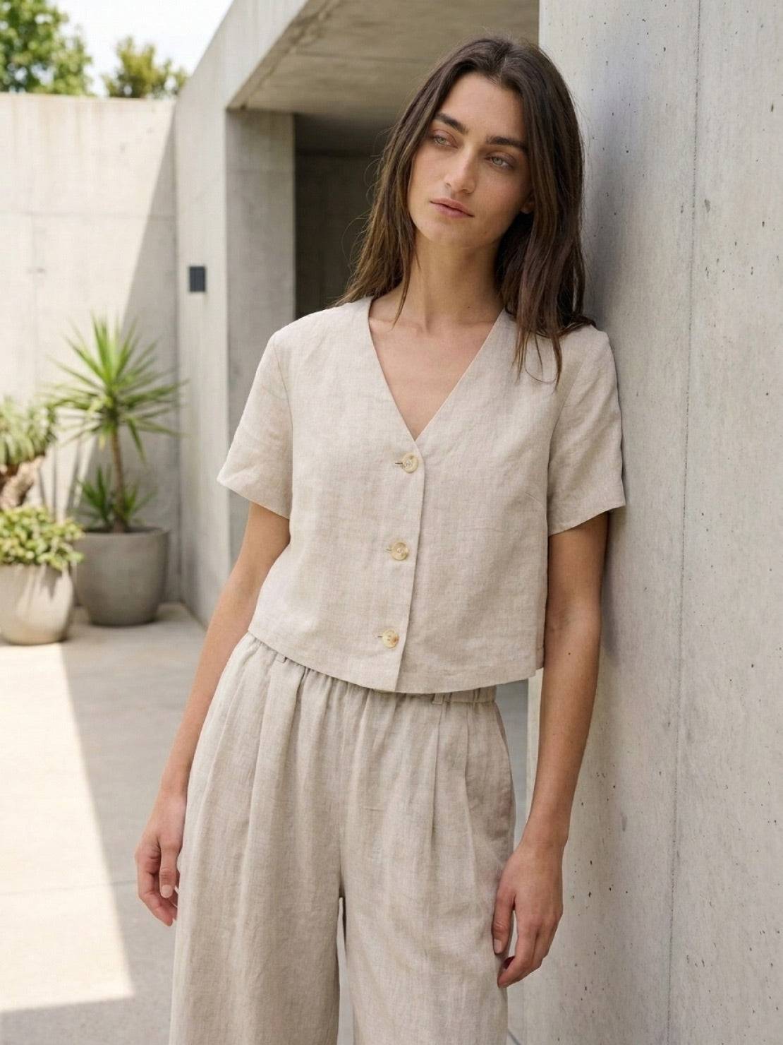 Lightweight 100% linen French top with V-neck, short sleeves, button detail, and relaxed boxy fit in light khaki and off white.