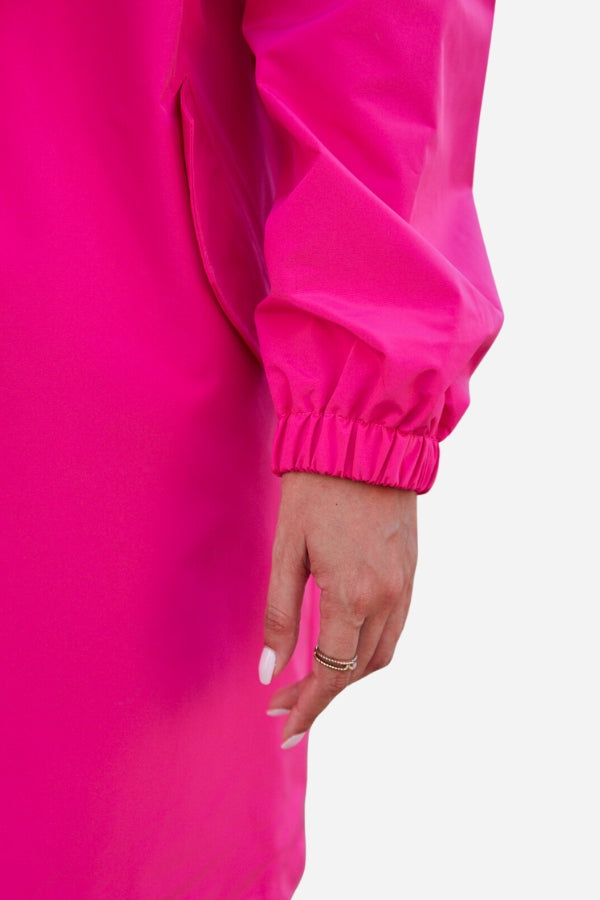 Close-up of a vibrant Barbara Pink Raincoat windbreaker sleeve with elastic cuff on model’s arm