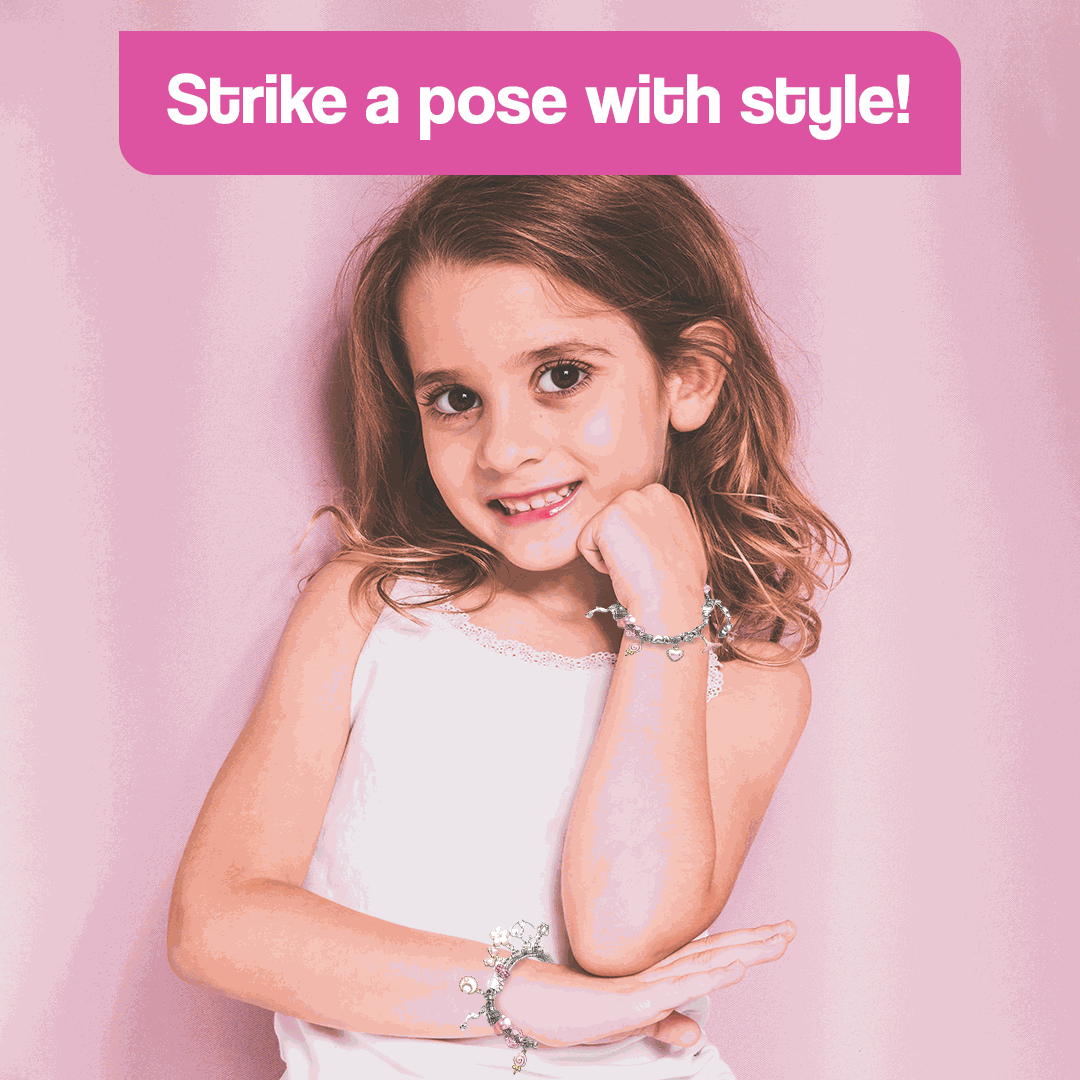 Young girl wearing colorful bracelets made with a kids bracelet-making kit showing creative style on pink background