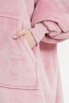Pink oversized ultra soft hooded blanket with large front pocket and ribbed cuff detail