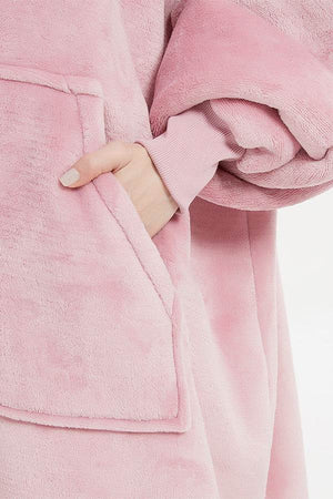 Pink oversized ultra soft hooded blanket with large front pocket and ribbed cuff detail