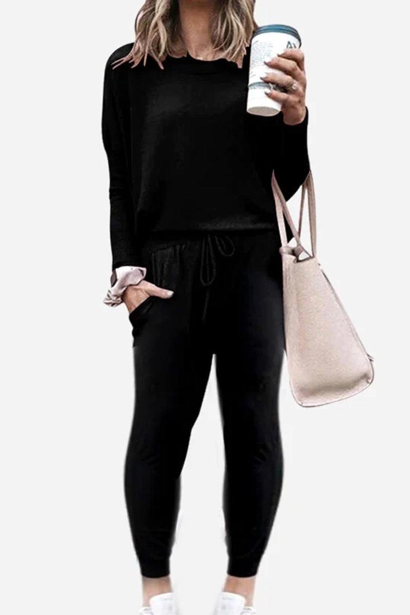woman wearing black Cozy Chic Two-Piece Sweatsuit holding coffee cup and beige tote bag