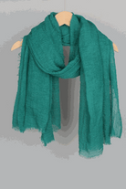 Green linen Color-POP Scarf hanging on wooden hanger, lightweight and breathable, all-weather ready, eco-friendly fabric.