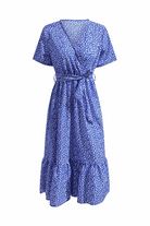Charming floral boho maxi dress with wrap V-neck, belted waist, ruffle hem, short sleeves, and blue floral print.