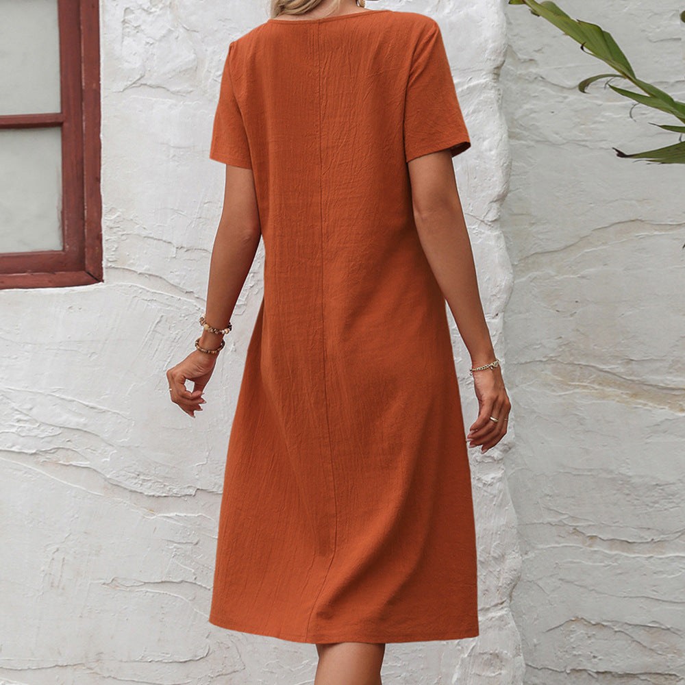 Back view of woman wearing Radiant Escape Panelled Beach Dress in rust orange midi length with short sleeves and round neckline