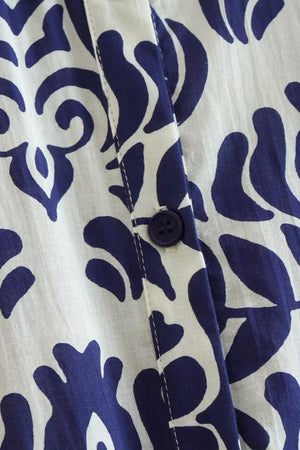 Close-up of blue floral lantern sleeves pattern with button on white polyester fabric