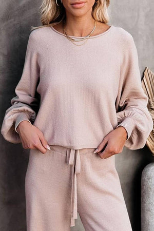 Woman wearing beige round neck loose fit cozy two-piece set with long sleeves and drawstring pants