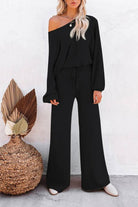 Black round neck loose fit cozy two-piece set with wide-leg pants and long sleeves worn by woman