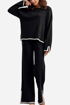 Long sleeved relaxed fit black two-piece lounge set with white trim and wide-leg pants