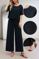 Black loose fit co-ord set with relaxed short sleeve top and wide-leg trousers in soft, breathable fabric.