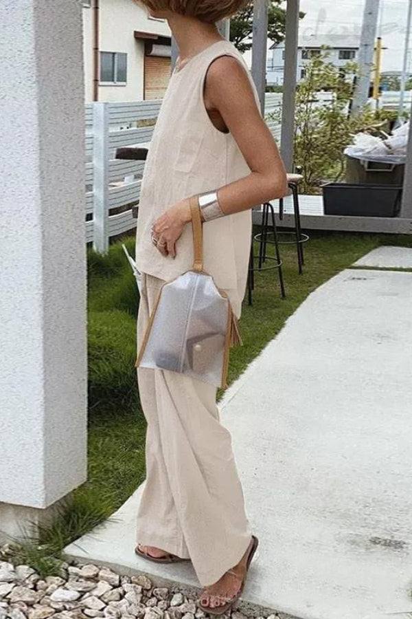 Woman wearing loose solid color sleeveless two-piece set with relaxed fit pants outdoors