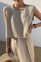 Woman wearing beige Casual Radiance Loose-Fit Combo sleeveless top and loose pants, styled for casual comfort and elegance.