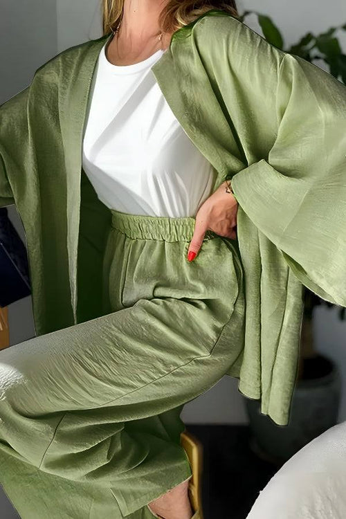Woman wearing chic comfort kimono two-piece set in soft green lounge wear