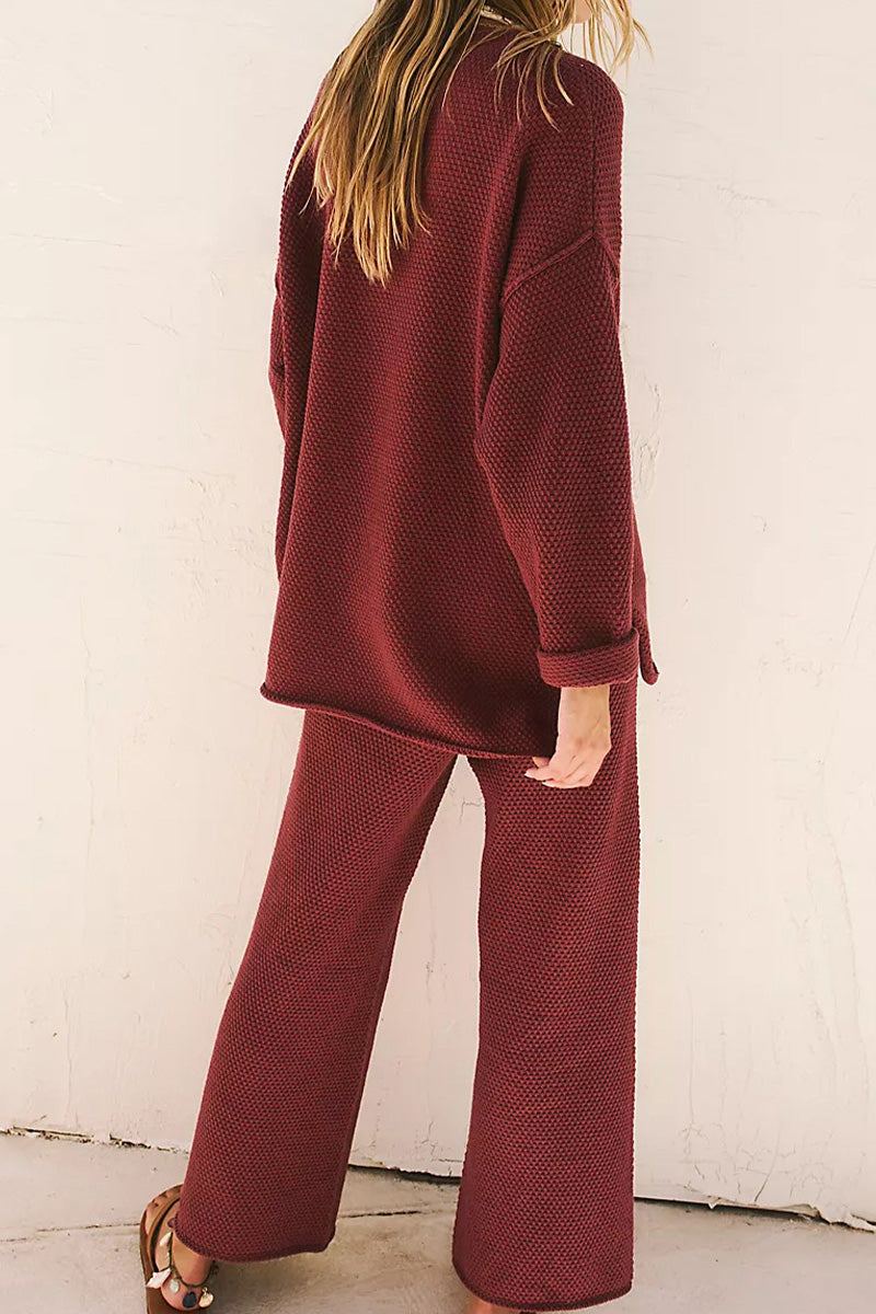Woman wearing a maroon Multi-Weather Comfort oversized two-piece set with long sleeves and wide pants.