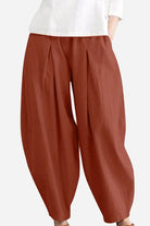 Rusty orange solid color wide leg cotton pleated pants on model