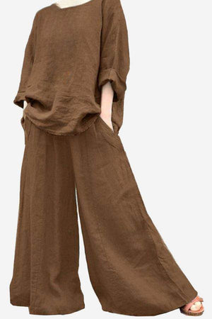 Brown wide leg pants with pockets styled with a loose brown top and rolled sleeves.