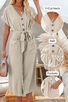 Beige V-neck lace-up jumpsuit with tie belt and front pockets, featuring wide sleeves and wide-leg pants.