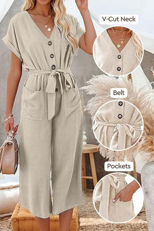 Beige V-neck lace-up jumpsuit with tie belt and front pockets, featuring wide sleeves and wide-leg pants.