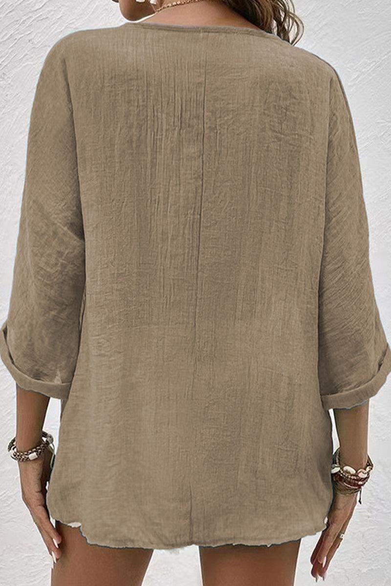 Back view of beige artisanal crinkle fabric button front tunic with rolled sleeves