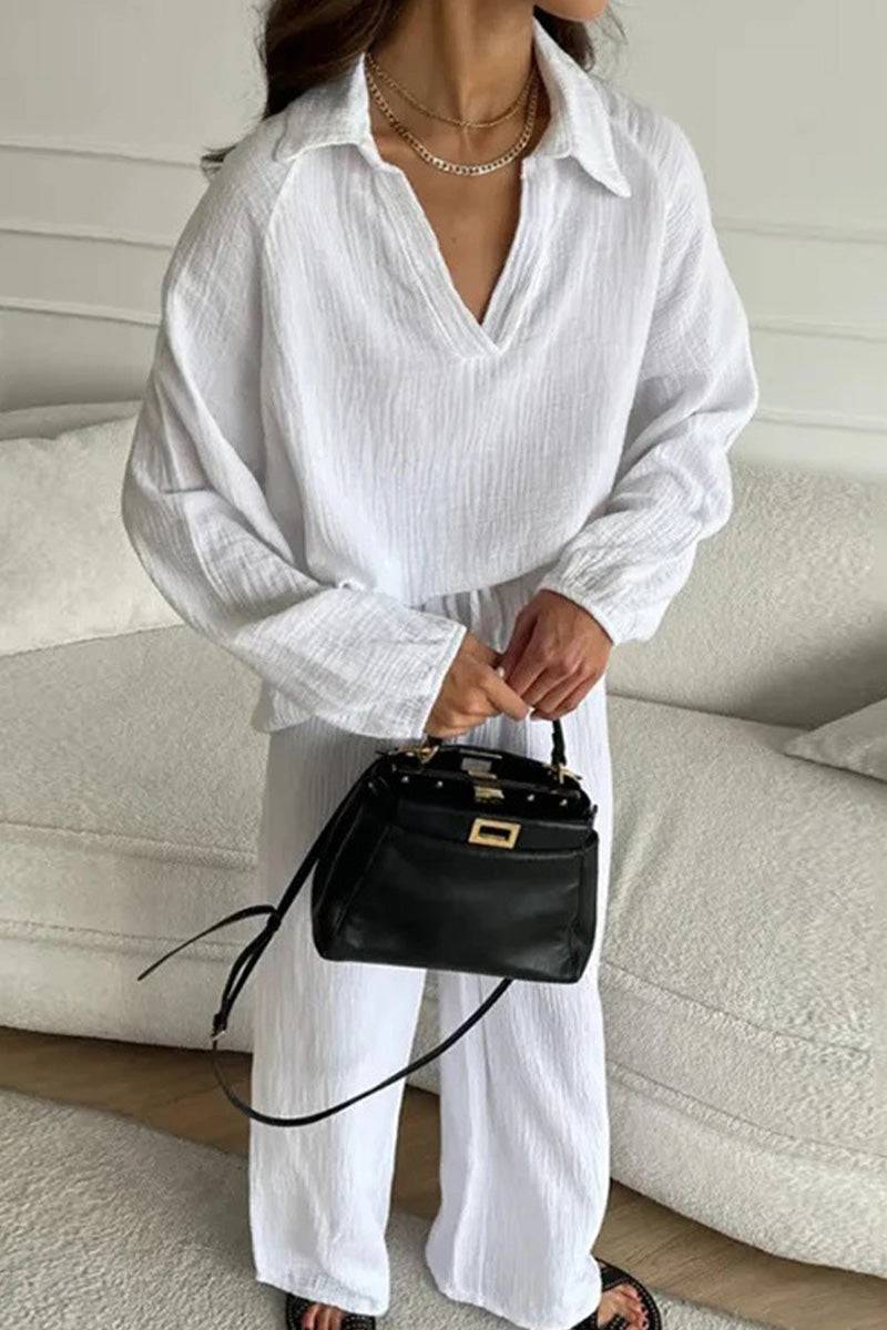 White cotton collared two-piece set with bishop sleeves and loose fit, styled with a black handbag