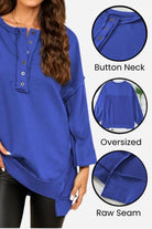 Blue oversized urban sweatshirt with button neck, raw seam details, and asymmetrical hem.