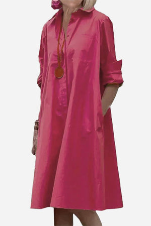 Pink long shirt-style dress with rolled sleeves and a relaxed fit