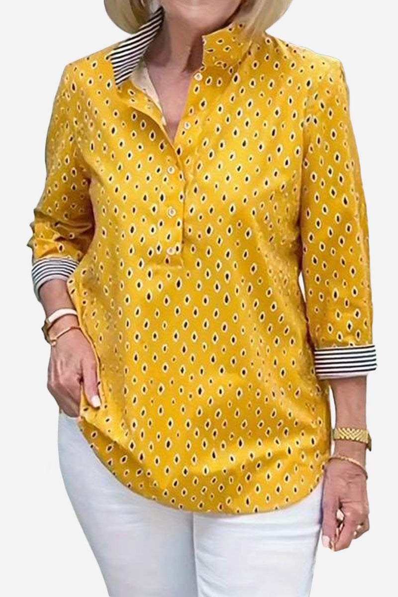 Yellow Boho Chic Resort Blouse with polka dots and striped collar and cuffs, three-quarter sleeves, lightweight fabric, styled on woman with white pants