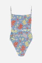 Tan-Through open back one-piece swimsuit with colorful coral print on blue background, featuring adjustable straps and high-cut legs.