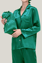 Green classic Mulberry silk pajama set with matching sleep cap held by model