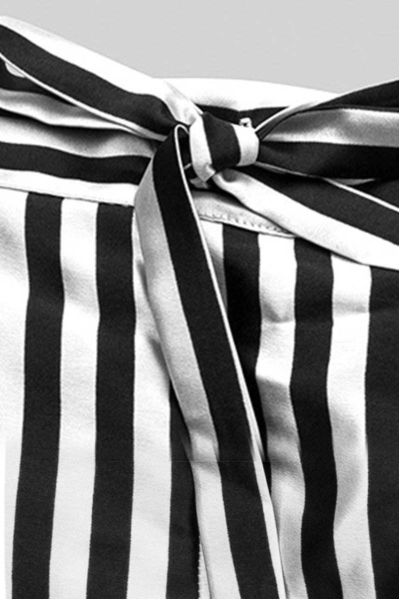 Close-up of black and white striped mulberry silk pajama fabric with tied waistband detail