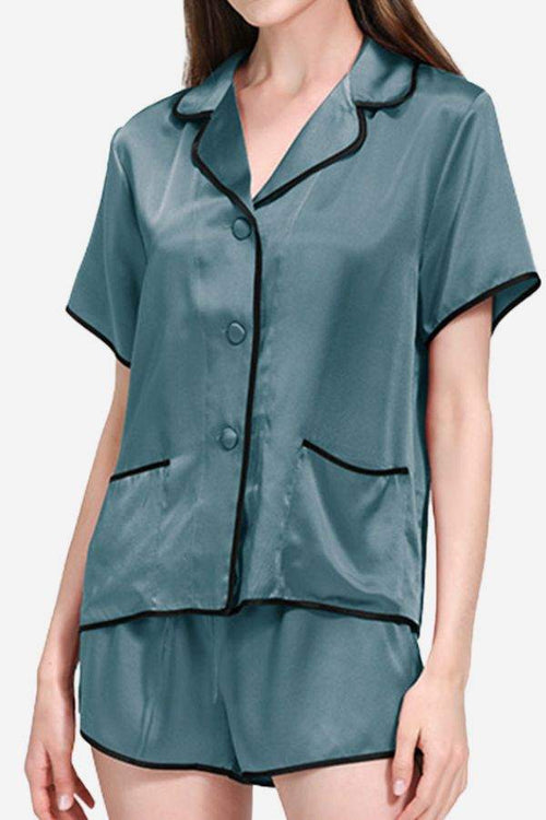 Women wearing a 100% mulberry silk Hemd pajama set with black trim, short sleeves, and shorts