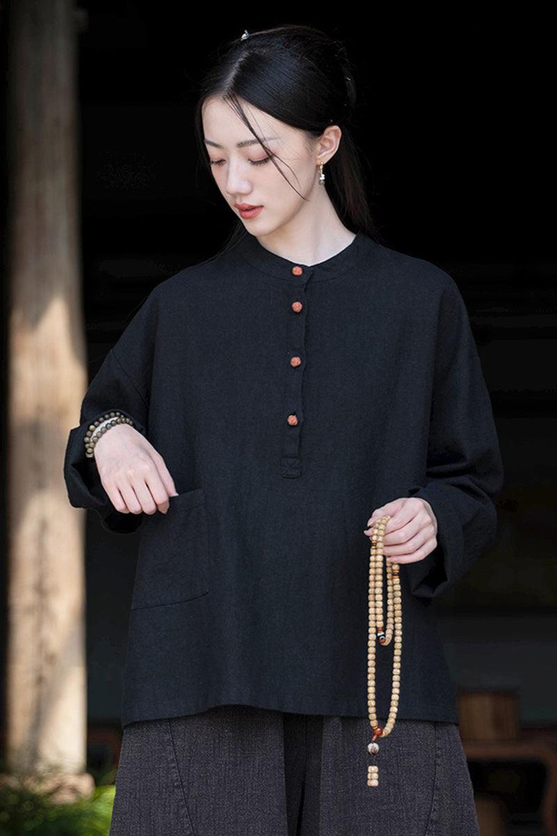 Woman wearing black Ramie Linen & Cotton loose blouse with wooden buttons and side pocket
