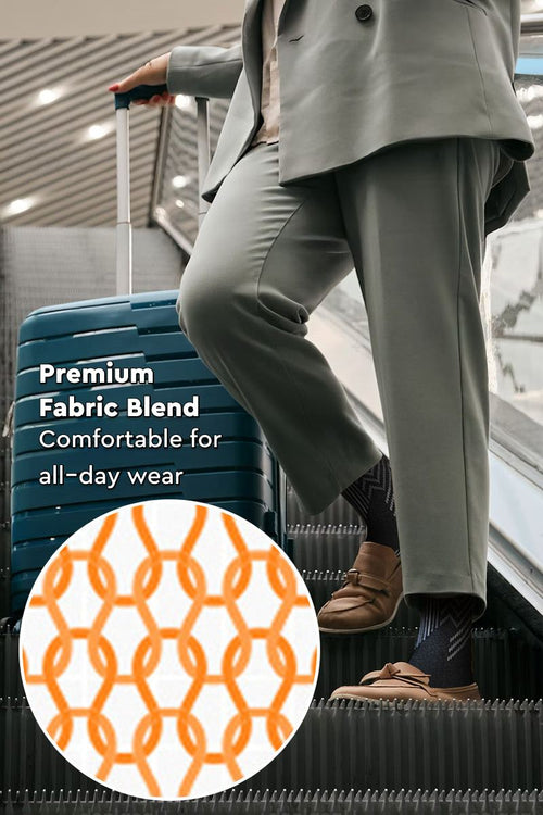 Person wearing premium compression socks with patterned design on escalator near suitcase for travel comfort