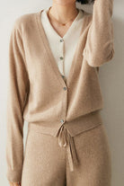 Woman wearing beige single-breasted cashmere wool cardigan and matching pants