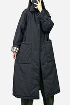 Plus size oversized black windbreaker parka with large pockets and long sleeves worn by model