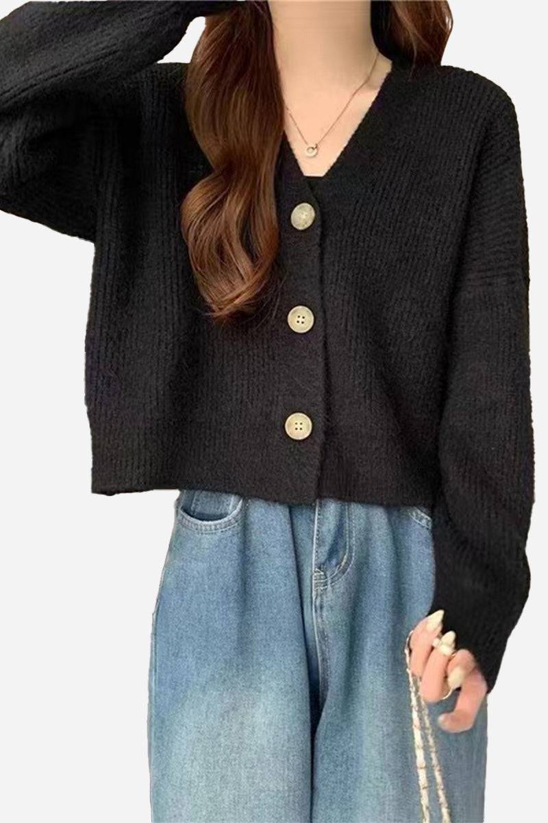 Black casual loose boxy cardigan with oversized fit and buttons worn with jeans
