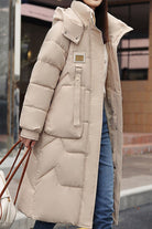 Beige FrostLine Long Coat, lightweight insulated winter coat with hood and pockets, ideal for cold weather and travel.