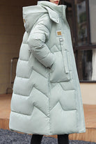 Lightweight insulated FrostLine Long Coat in light gray with hood and side pockets for winter travel and cold weather.