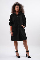 Travel-smart waterproof hooded windbreaker in black with adjustable hood and sleek design for elegant rain protection.