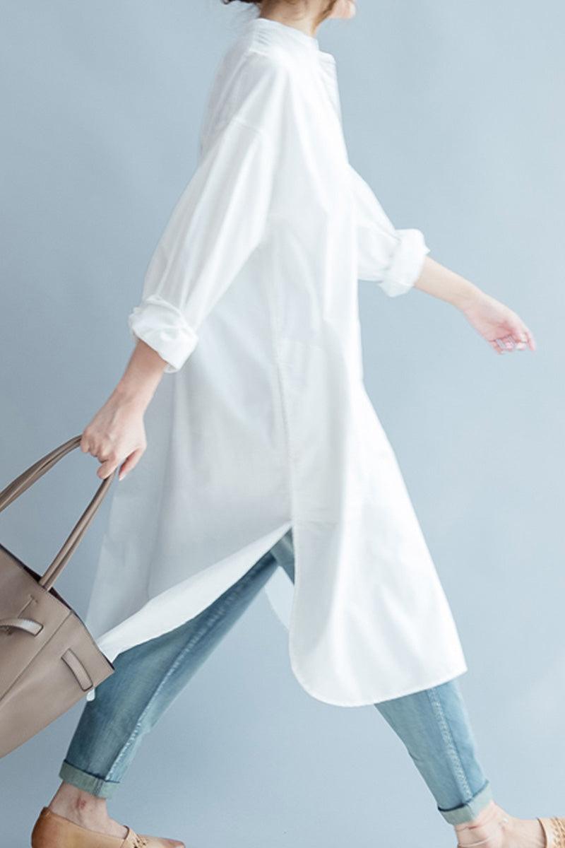 Woman wearing white pure cotton long shirt with rolled sleeves and light blue jeans carrying beige handbag
