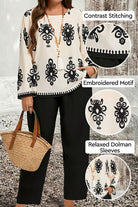 Plus Size Easy Elegance set featuring embroidered black and white motif top with dolman sleeves and black pants