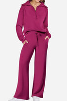 Woman wearing a magenta Loungewear Buttersoft Tracksuit Set with zip-up top and wide-leg pants in cozy, soft fabric.