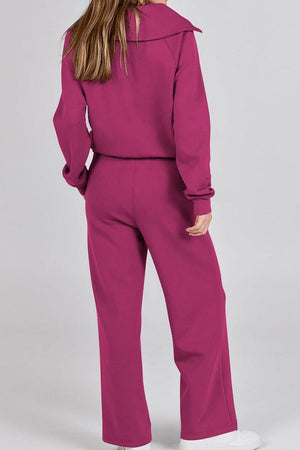 Woman wearing magenta loungewear buttersoft tracksuit set with oversized fit and long sleeves.