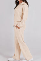 Woman wearing beige Loungewear Buttersoft Tracksuit Set with zip-up hoodie and relaxed fit pants.