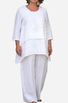 White loose drape two-piece set with asymmetrical oversized top and wide-leg pants.