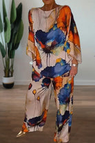 Plus size vibrant floral matching set with flowy top and pants in bright blue and orange floral print