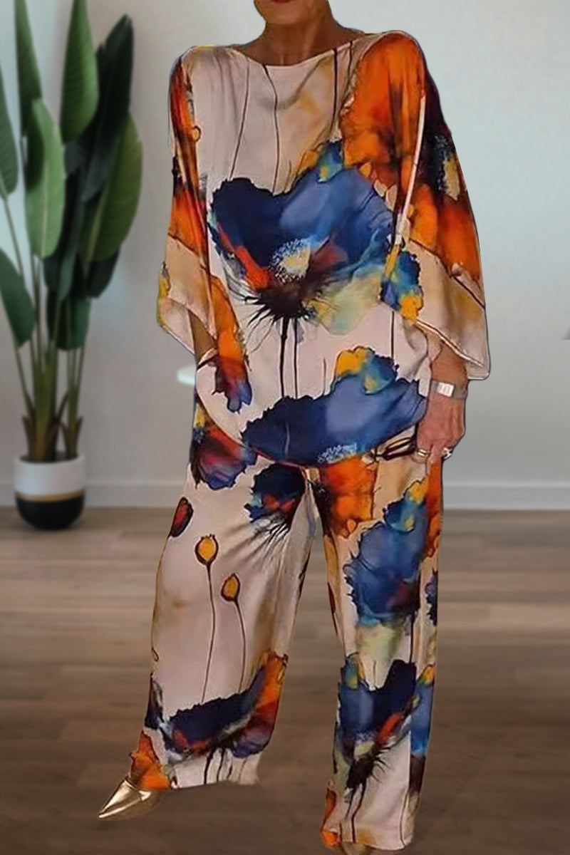 Plus size vibrant floral matching set with flowy top and pants in bright blue and orange floral print