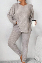 Woman wearing a beige Body Confident Oversized Knit two-piece set with ribbed texture holding a coffee cup.